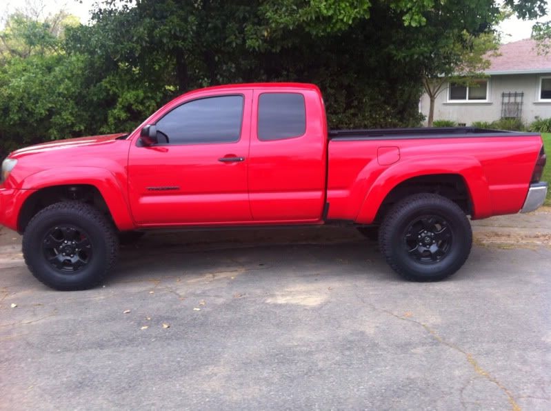 Red toyota tacoma with black wheels